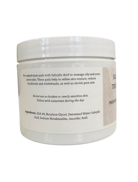 A white plastic jar of Salicylic Acid Toner Pads with a white screw-on lid and a beige label, shown against a plain white background.